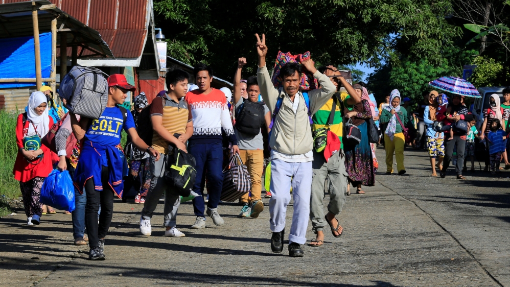 Residents proceed to a evacuation center outside of Marawi City [Romeo Ranoco/Reuters]