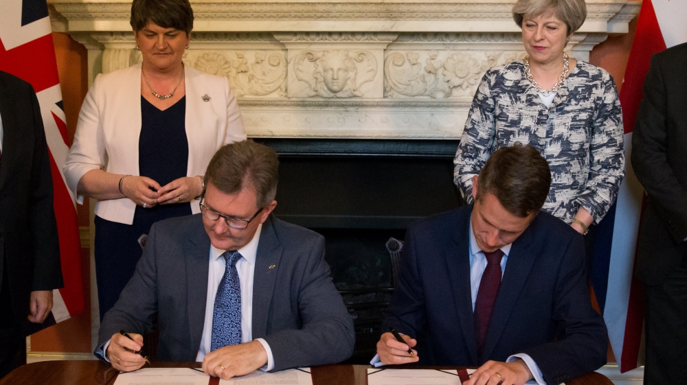 Former DUP MP Jeffrey Donaldson signed paperwork with Britain’s then Parliamentary Secretary to the Treasury, and Chief Whip, Gavin Williamson at 10 Downing Street on June 26, 2017. Donaldson rose through ranks to become DUP leader