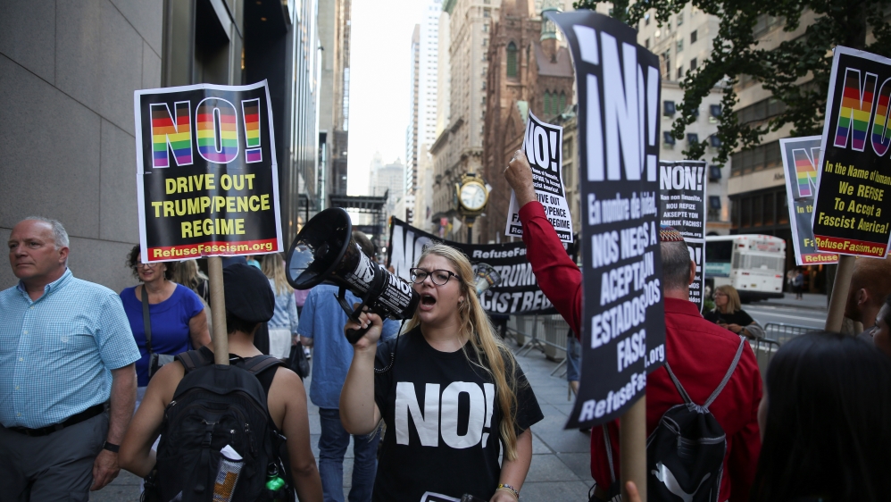 Activists hold placards in New York as they protest against the U.S. Supreme Court decision to revive parts of travel ban