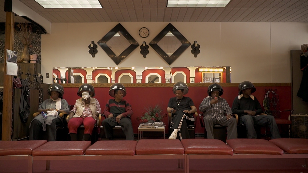 Customers of Roberto's barber shop in Detroit [Screengrab/Al Jazeera]