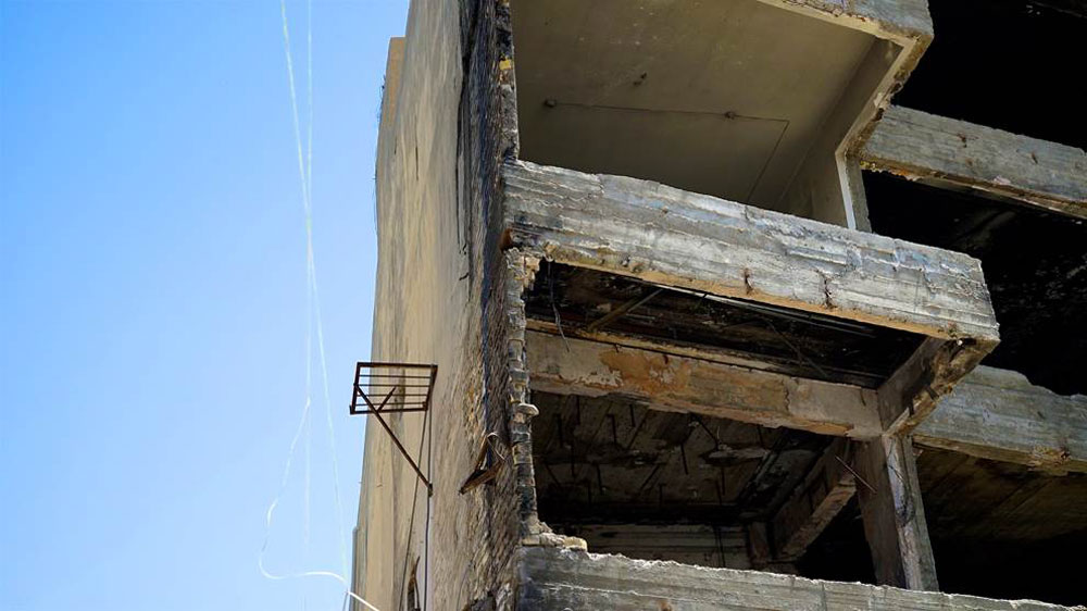  The skeletons of charred buildings stood as a memorial to all those who perished [Dima Shaibani/Al Jazeera] 