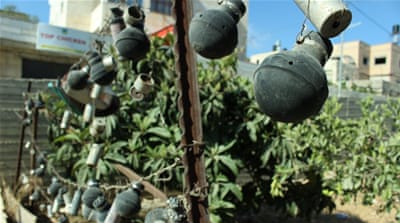 The Tamimi family collects tear gas canisters and sound bombs from the village's protests [Jaclynn Ashly/Al Jazeera]