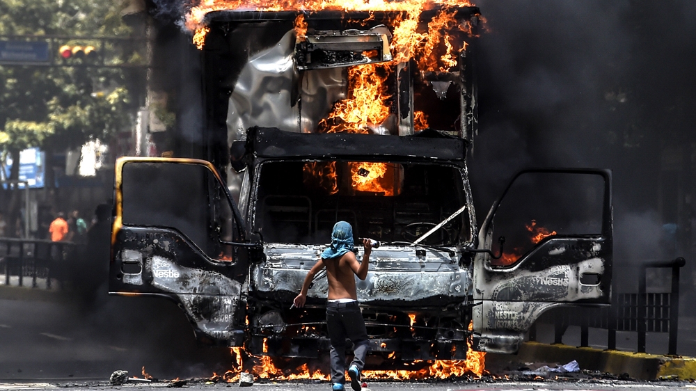 Venezuela has grappled with violence as low crude oil prices forced government to cut back its socialist programmes [AFP]