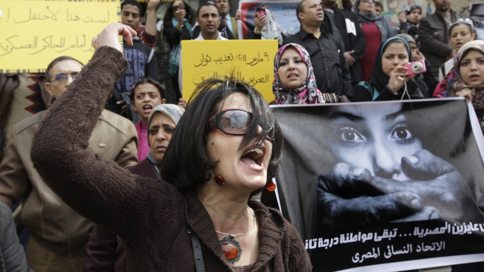 Egyptian female protester hold posters and shout slogans.s