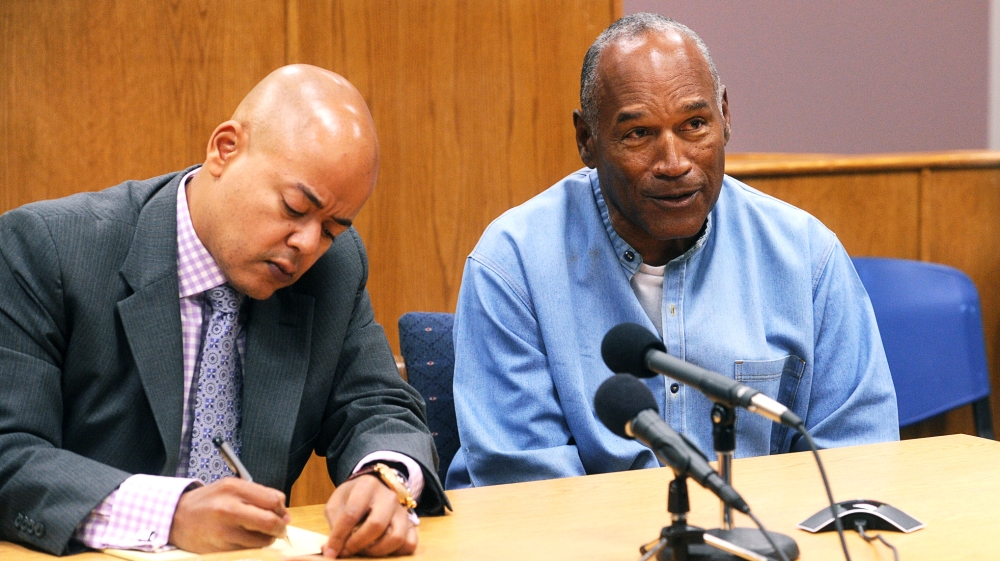 O.J. Simpson reacts at his parole hearing with attorney Malcolm LaVergne at Lovelock Correctional Centre in Lovelock