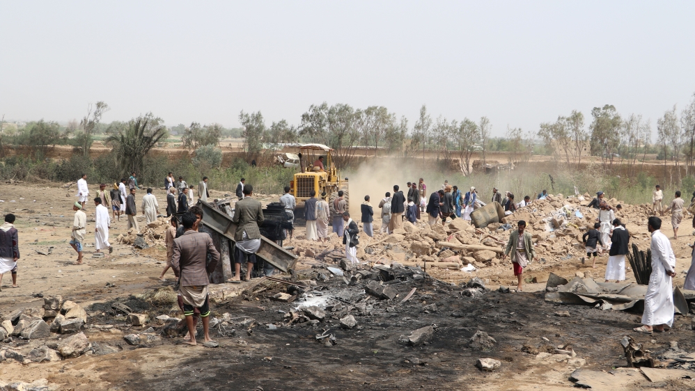 People gather as a bulldozer removes debris of a house to recover a missing woman at the site of a Saudi-led air strike on an outskirt of the northwestern city of Saada