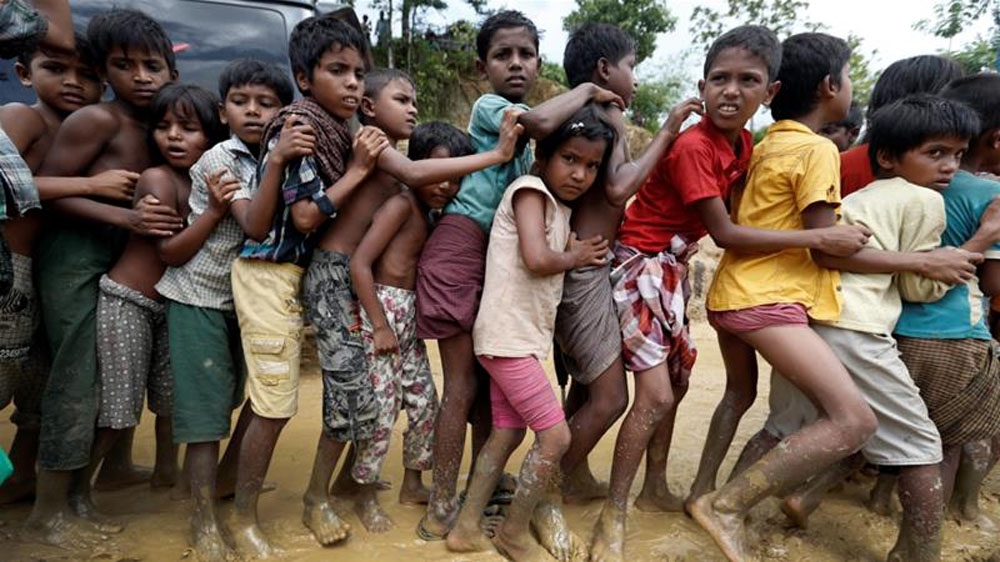 Rohingya refugee children queue for aid in Cox''s Bazar, Bangladesh