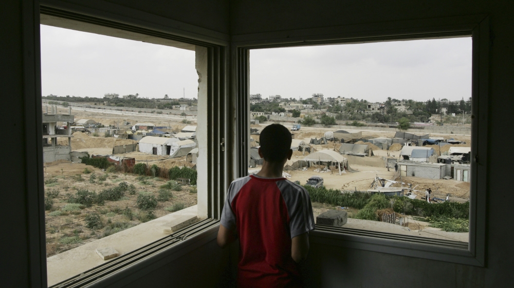 Gaza youth looking over rubble