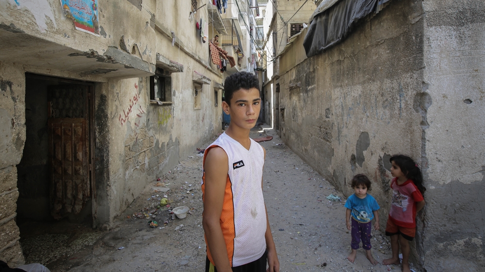 Muntaser was playing football on the beach when an Israeli missile struck, killing four of his relatives, including his brother [Ezz Zanoun/Al Jazeera]