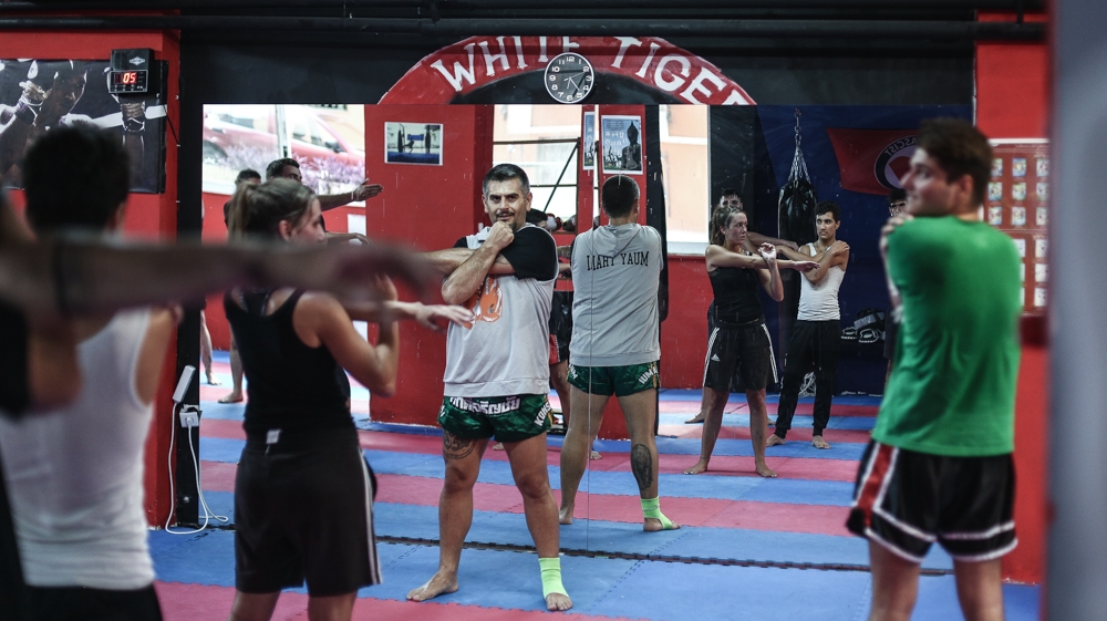 Ilias Lamprou leads a novice course in stretches before drilling starts [Nick Paleologos/SOOC/Al Jazeera]