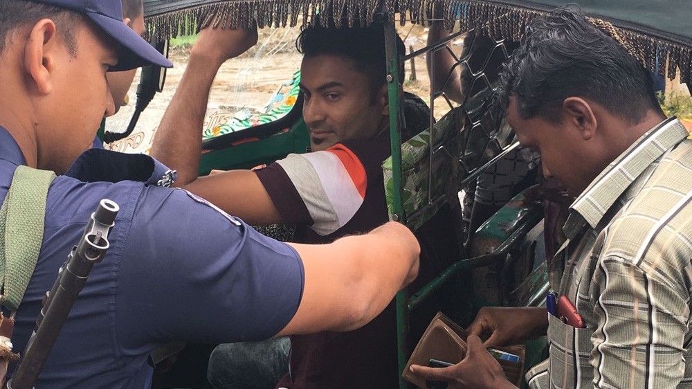 Bangladesh police check identification papers of Rohingya some 40km from Cox's Bazar [Saif Khalid/Al Jazeera]