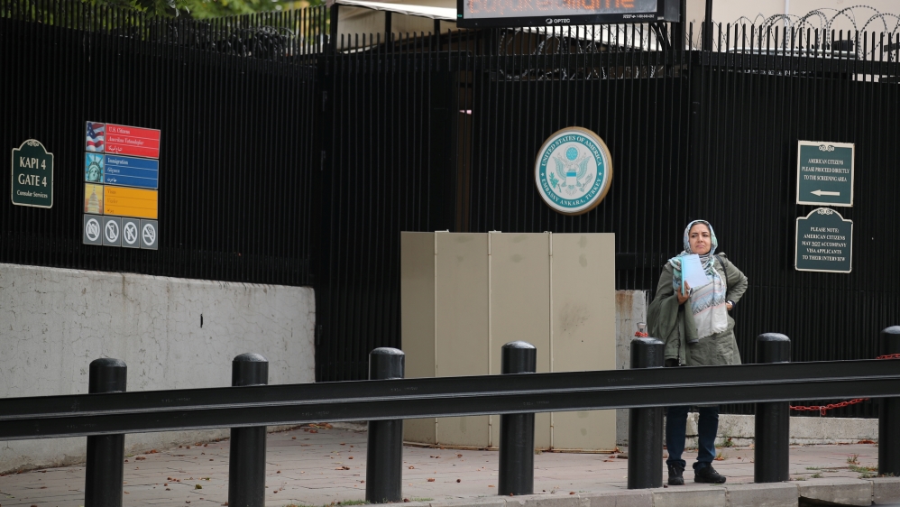 A woman waits in front of the visa application office entrance of the U.S. Embassy in Ankara