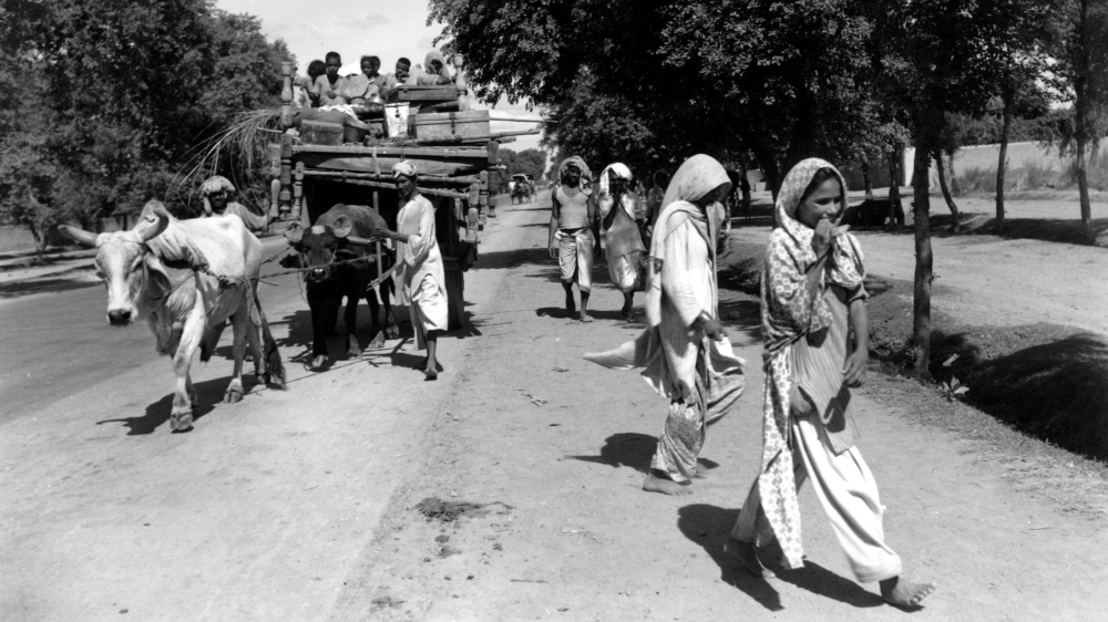 A bullock cart loaded with children and household goods belonging to a Muslim family fleeing from Hindu India moves along a road near Lahore, India on Aug. 26, 1947. The family is travelling to Pakist