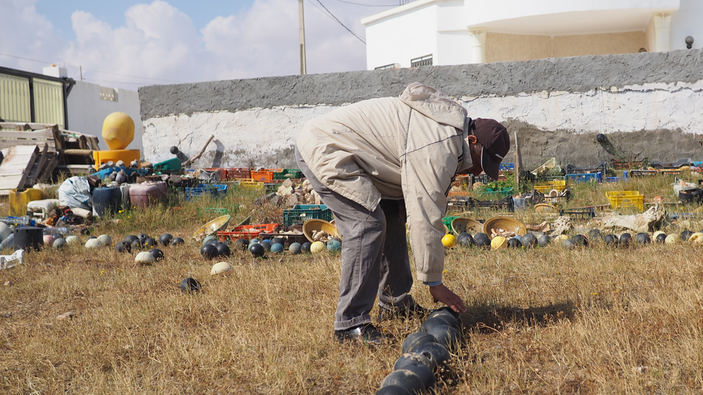 Mohsen at work in his small museum, which is visited by students as well as foreigners [Al Jazeera]