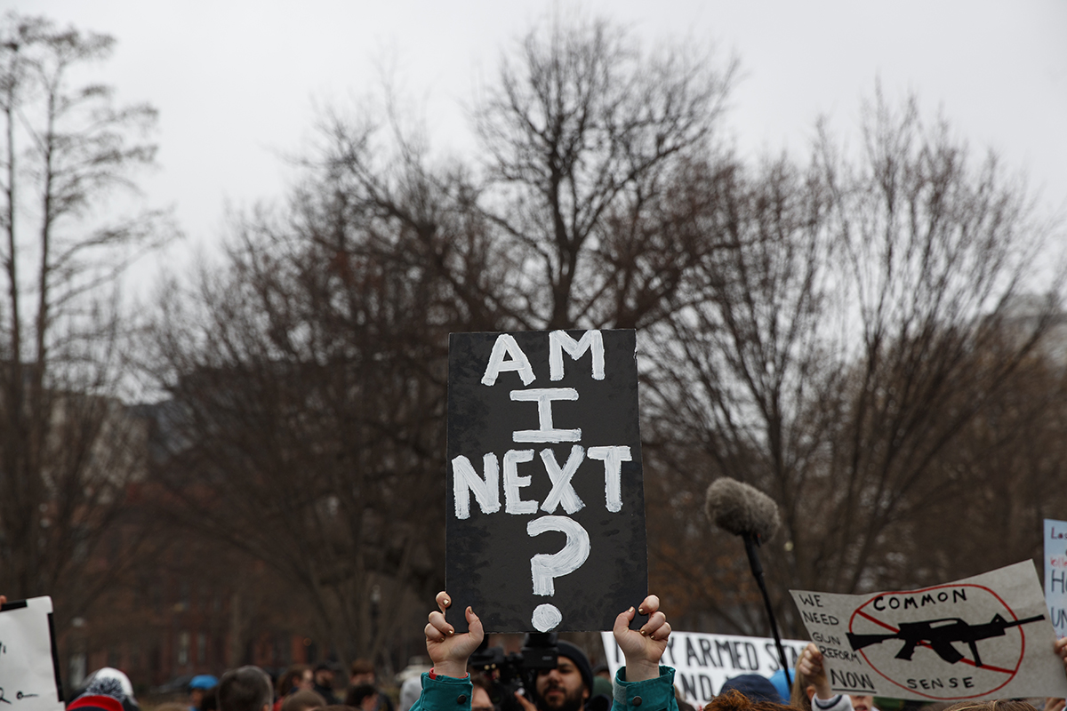 Demonstrators hold signs during a protest in favor of gun control reform in front of the White House, Monday, Feb. 19, 2018, in Washington. (AP Photo/Evan Vucci)