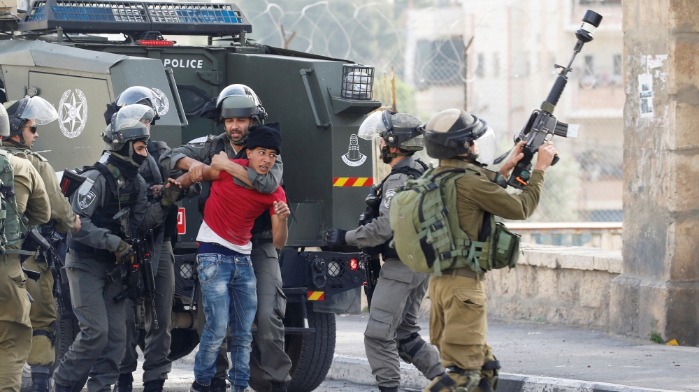 Israeli border policemen detain a Palestinian protester during clashes at a protest in support of Palestinian prisoners on hunger strike in Israeli jails, in the West Bank town of Bethlehem