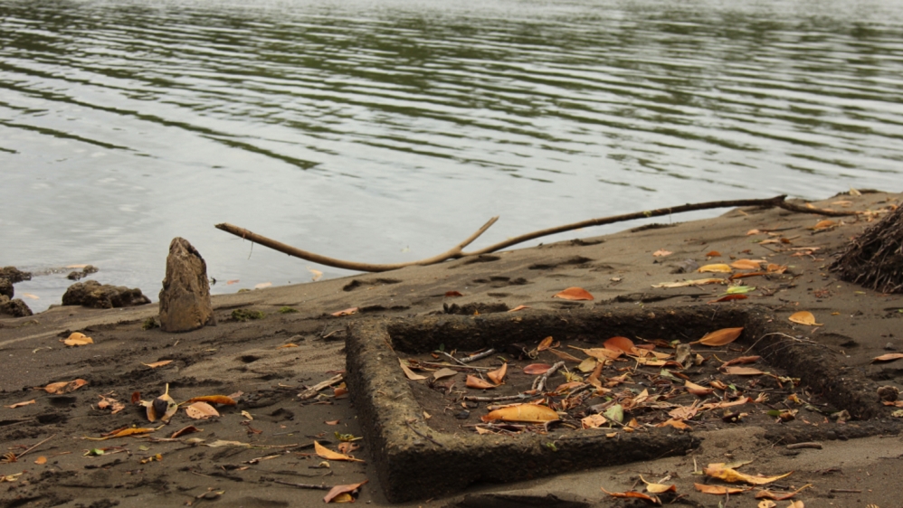 A slab of concrete in the mud indicates where the toilet in Sailosi Ramatu's first home used to be [Loes Witschge/Al Jazeera]