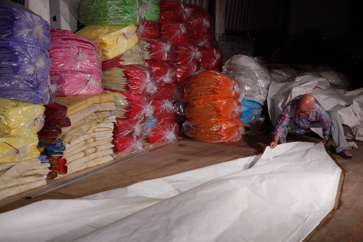 “The closer I am about to accomplish a huge sky lantern, the more fearful that it will be destroyed by mistakes.” Experienced sky lantern maker Min Shu Hu makes one of the two 15-feet-tall sky lantern