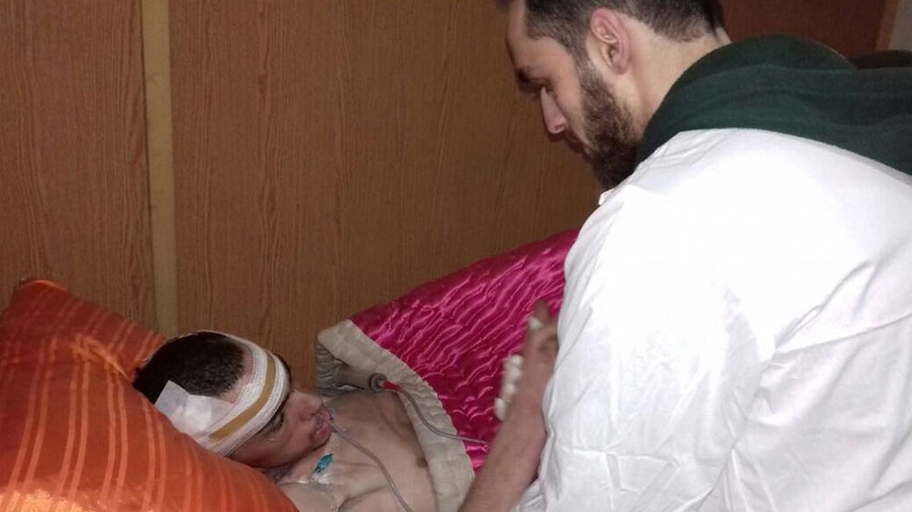Bassam Yousef helps a patient at a medical checkpoint in Eastern Ghouta [Courtesy of Bassam Yousef]