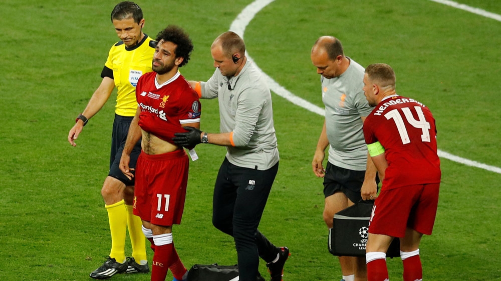 Liverpool's Mohamed Salah receives medical attention after sustaining an injury [Phil Noble/Reuters]