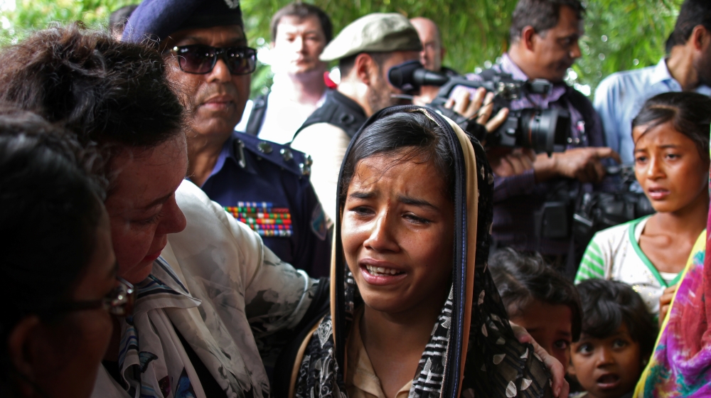 British United Nations Ambassador Karen Pierce consoles a twelve-year-old Rohingya refugee near Cox’s Bazar, in Bangladesh
