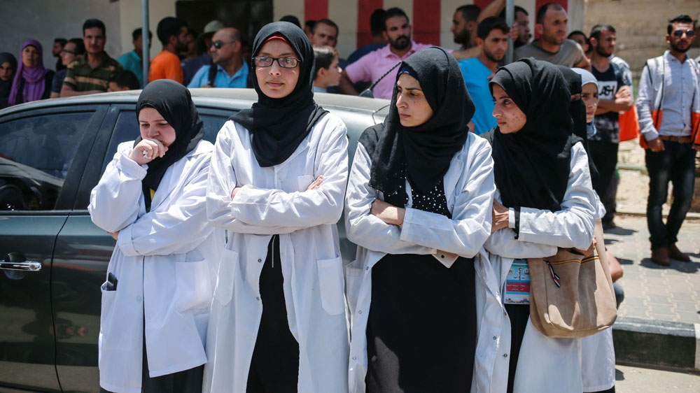 Medics attending the funeral of their colleague, Razan [Hossam Salem/ Al Jazeera]