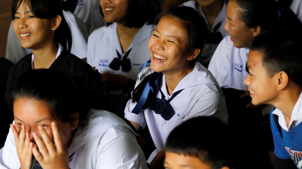 Classmates react after a teacher announces that some of the boys have been rescued at Mae Sai Prasitsart school [Tyrone Siu/Reuters]