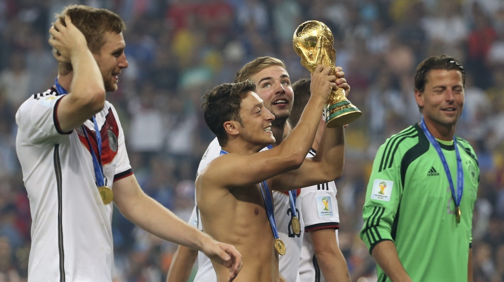 

Ozil holds the World Cup trophy after Germany beat Argentina at the 2014 final in Brazil [Antonio Lacerda/EPA]

Ozil holds the World Cup trophy after Germany beat Argentina at the 2014 final in Brazil [Antonio Lacerda/EPA]
