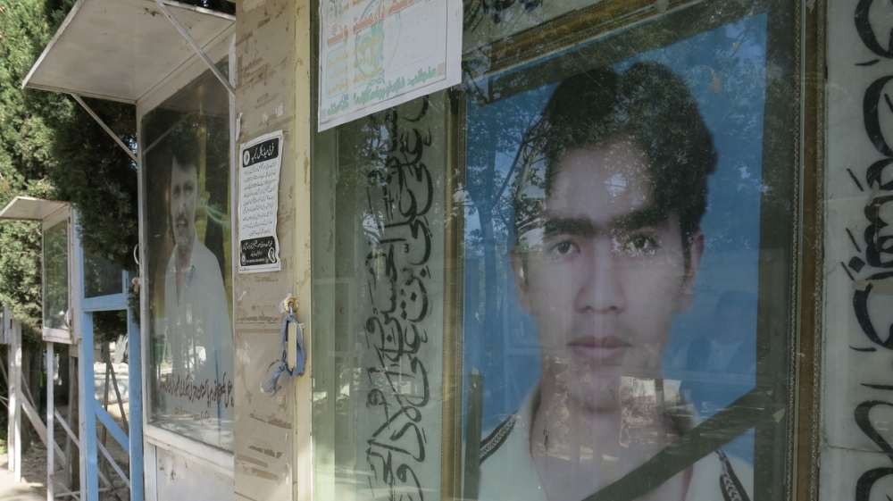 Images of those killed in the attacks on the Hazara posted at a 'martyr's graveyard' [Asad Hashim/Al Jazeera] [Al Jazeera]