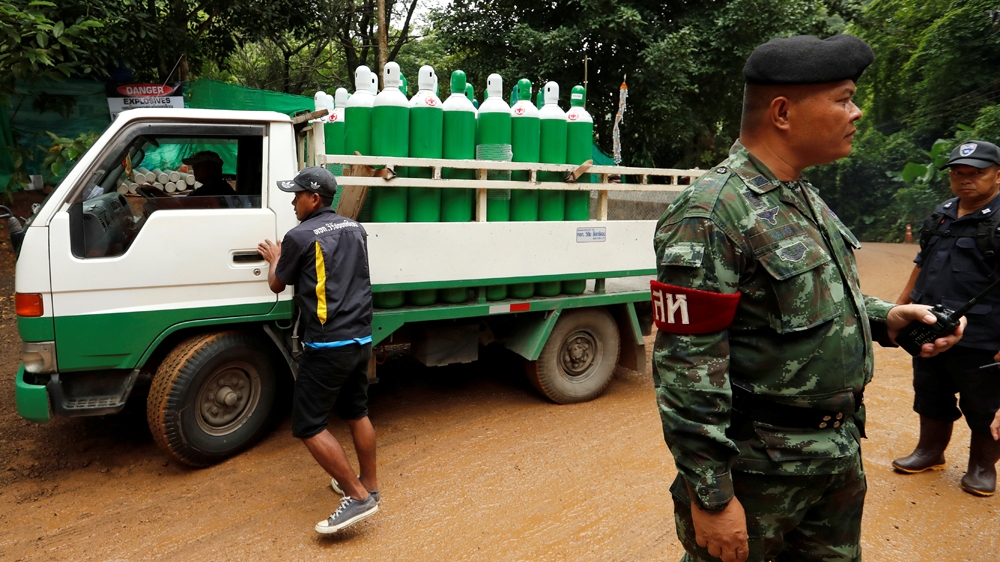 A truck carrying oxygen tanks arrives outside the cave complex on Sunday [Tyrone Siu/Reuters]