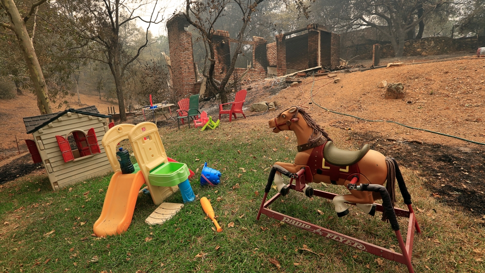 Toys stand untouched near a home destroyed by the fire west of Redding, California [Bob Strong/Reuters]