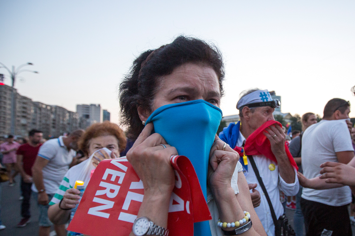 8. Protesters cover their faces as members of the Romanian Gendarmerie spray tear gas during an anti corruption process in the center of Bucharest on July 5th, the day when the bill bringing changes t