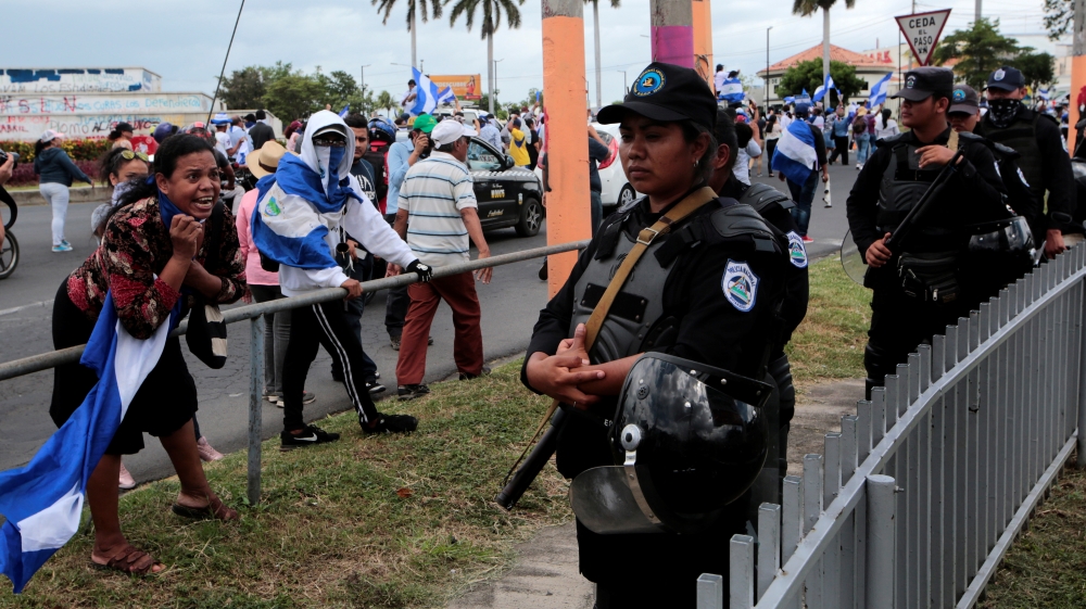 A demonstrator shouts slogans to riot police during a protest against Nicaraguan President Daniel Ortega's government in Managua [Oswaldo Rivas/Reuters]