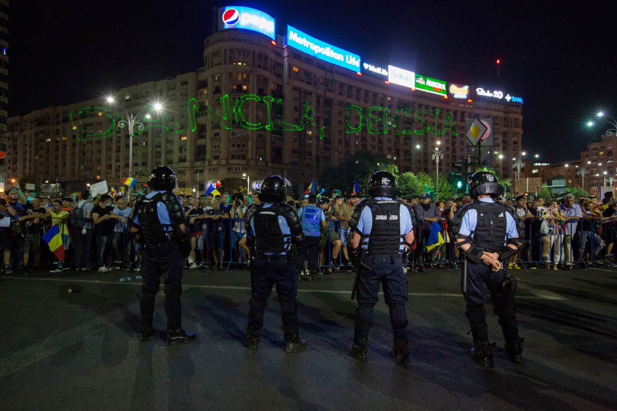 Messages asking for a non violent protest and for the resignation of the government were projected on buildings in the Victory square. [Alexandra Radu/Al Jazeera]