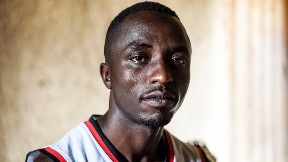 Abdul Sibomana says that through his coffee farm he hopes to pay homage to his parents and earn an income for his family [Azad Essa/Al Jazeera]