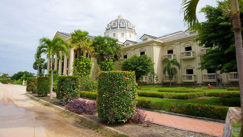 Workers tend to the garden outside the non-functioning casino at the resort [Andrew Nachemson/Al Jazeera]