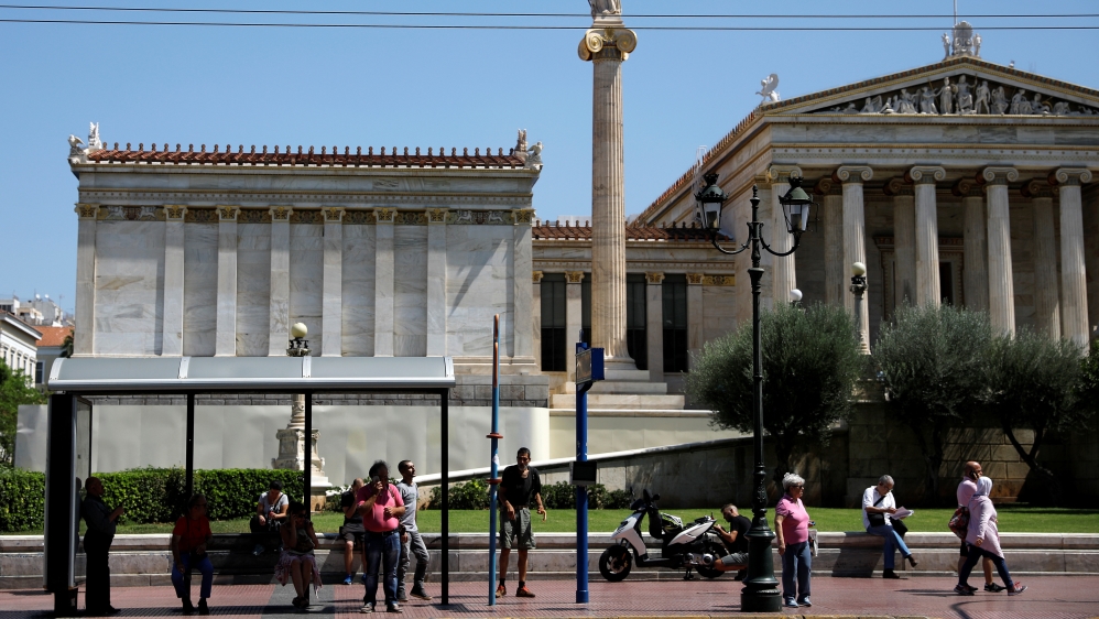 Pedestrians wait for the bus in central Athens [File: Alkis Konstantinidis/Reuters] 