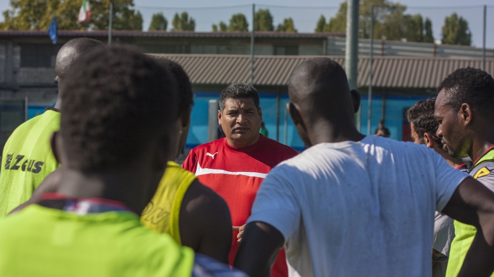 Luis Patino, a former pro-keeper in Peru, says he feels like a father as much as a manager. He teaches football, but also values, rules, and discipline [Alessio Perrone/Al Jazeera]
