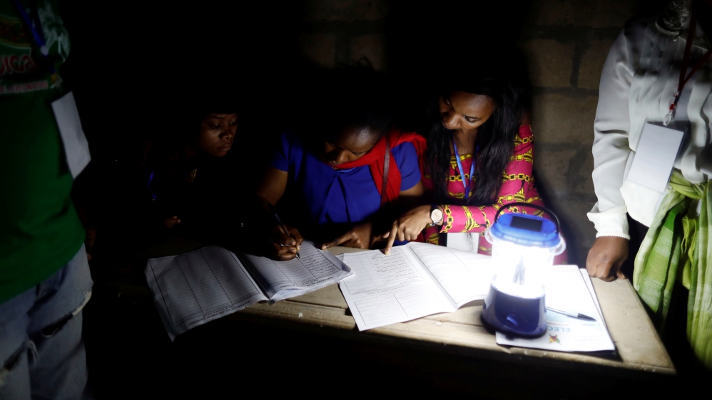 Election workers take part in vote counting during the presidential election in Yaounde,