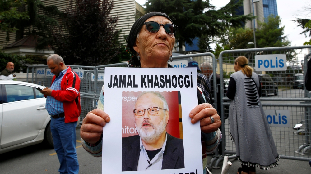 A human rights activist holds picture of Saudi journalist Jamal Khashoggi during a protest outside the Saudi Consulate in Istanbul