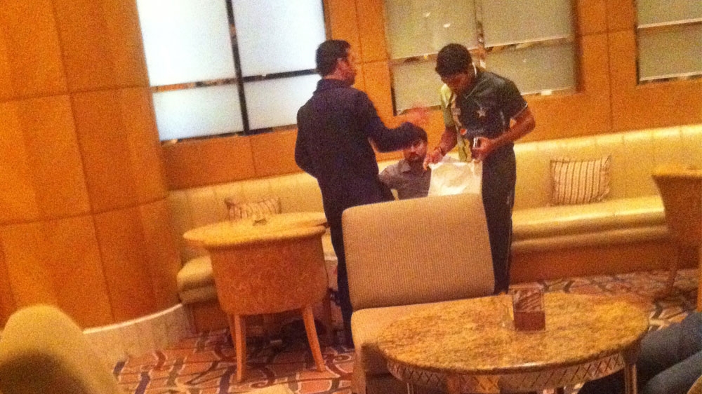 Pakistan's Umar Akmal, right, pictured with a Munawar associate. The player depicted is not implicated in any wrongdoing [Al Jazeera]