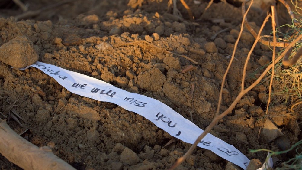 A makeshift grave marks one of the thousands of lives lost during Typhoon Haiyan.  [Al Jazeera]