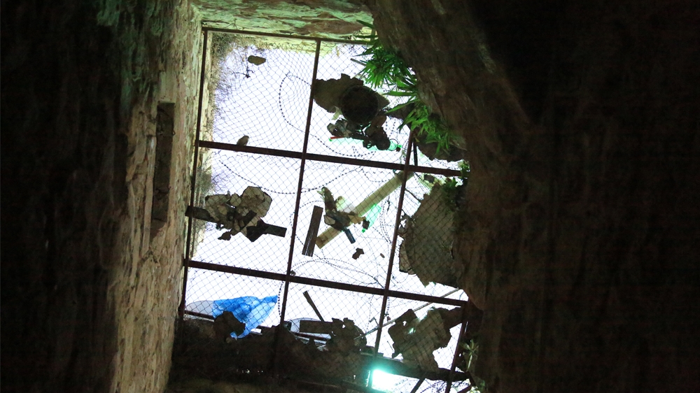 Wire mesh covers the top of the building to protect the Ewaiwe family from settler attacks [Mersiha Gadzo/Al Jazeera]