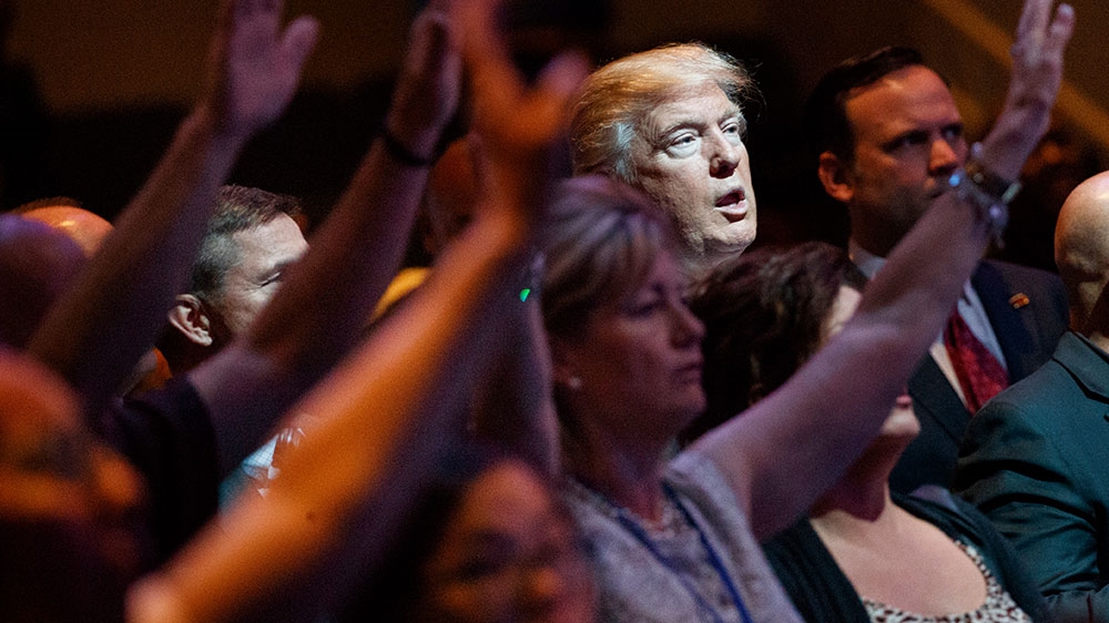 Republican presidential candidate Donald Trump stands during a service at the International Church of Las Vegas in Las Vegas