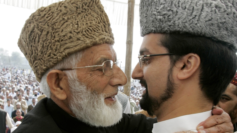 Mirwaiz Umar Farooq, (R) Chairman of Kashmir's moderate faction of All Parties Hurriyat (Freedom) Conference (APHC), and Syed Ali Shah Geelani Chairman of the hardliner faction of APHC hug on the occ
