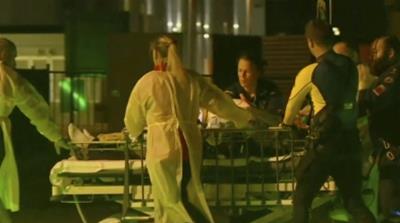 The victim of a shark attack is wheeled on stretcher by paramedics after a rescue helicopter transported him to Mackay Base Hospital, Queensland state, Australia [AP]