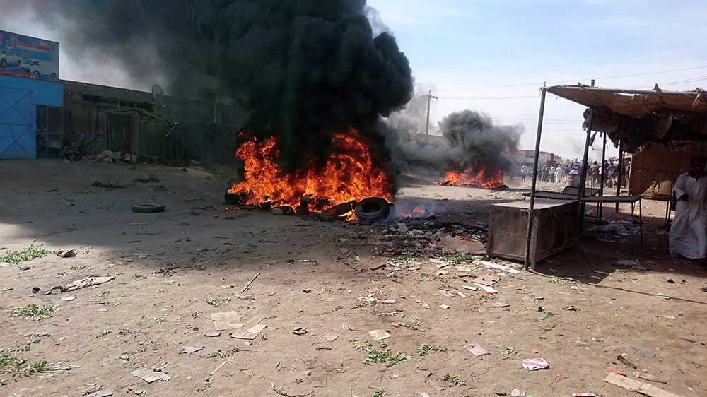 A bonfire is lit along the street during protests against price increases in Atbara, Nile River state in northeastern Sudan [El tayeb Siddig/Reuters]