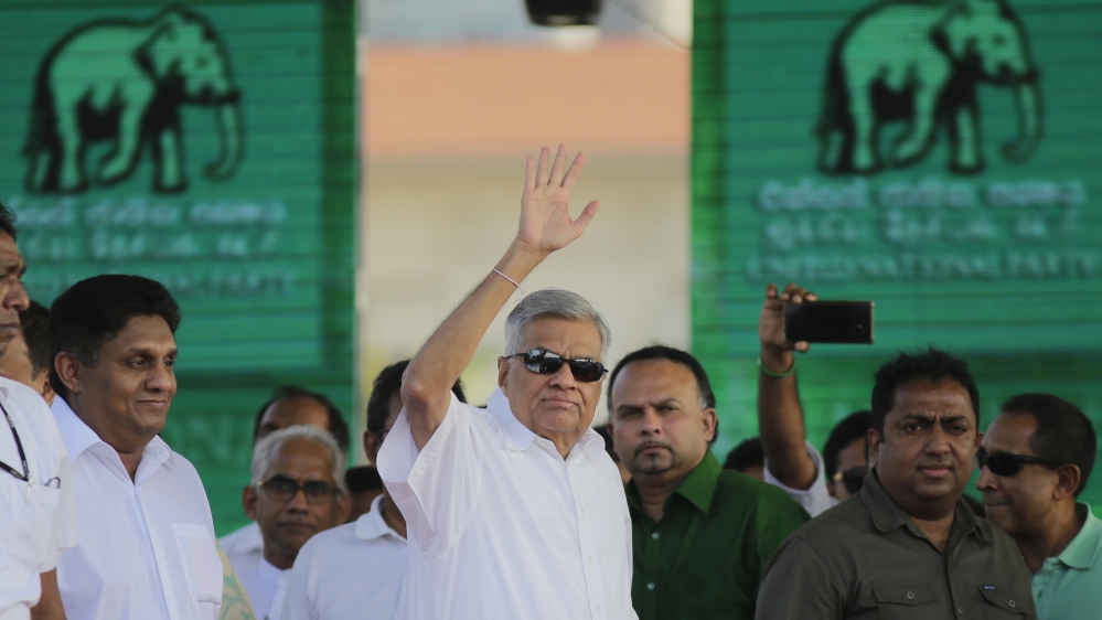 Wickremesinghe's (centre) government faces a difficult path ahead [Eranga Jayawardena/AP]