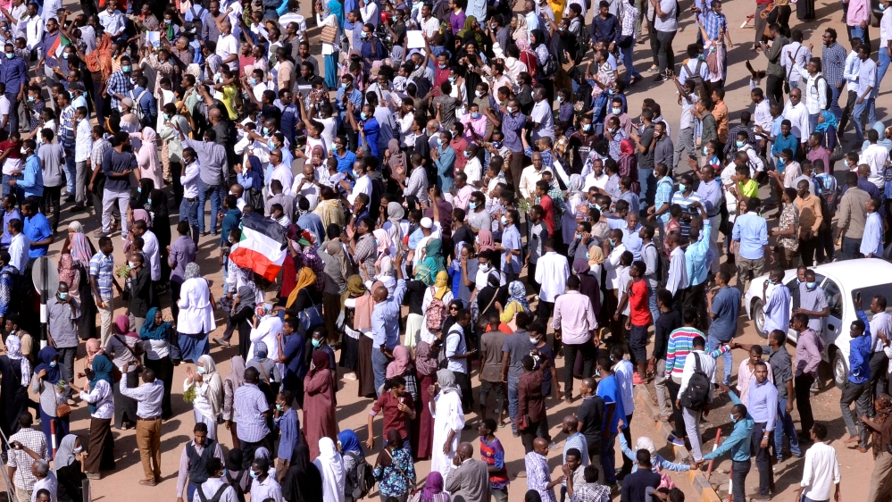 Sudanese demonstrators chant slogans as they march along the street during anti-government protests in Khartoum