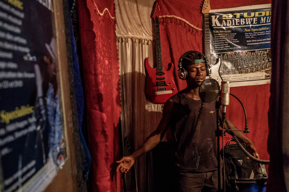 Asili Power (16) records his part of a song: “I am proud of myself when I walk over the streets.” Their music has made the young hip-hoppers more confident and resilient.